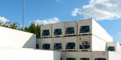 Stacked refrigerated storage containers outdoors.