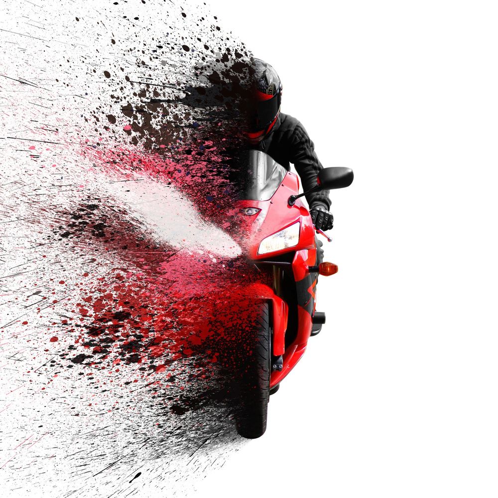 A motorcyclist on a red bike with an artistic paint splatter effect.