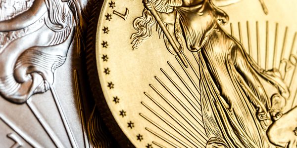 Close-up of gold and silver coins with detailed engravings.