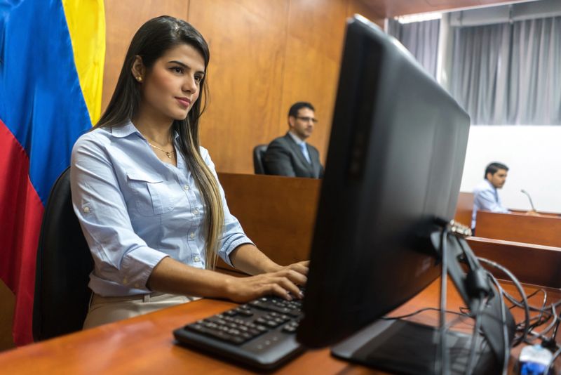 Clerk typing the session in trial at the courtroom - legal system concepts