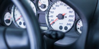 Close-up of a car speedometer showing speed in kilometers per hour.