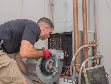 Technician repairing HVAC system.