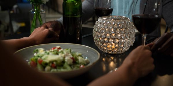 Cozy dinner setup with wine and salad.