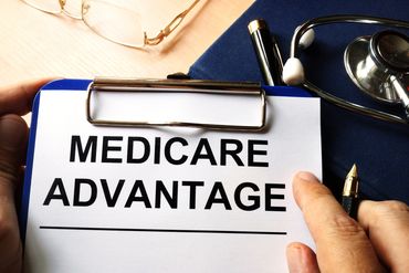 Clipboard with Medicare Advantage form and stethoscope.