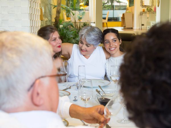 Family enjoying a joyful meal together at a beautifully set table indoors.