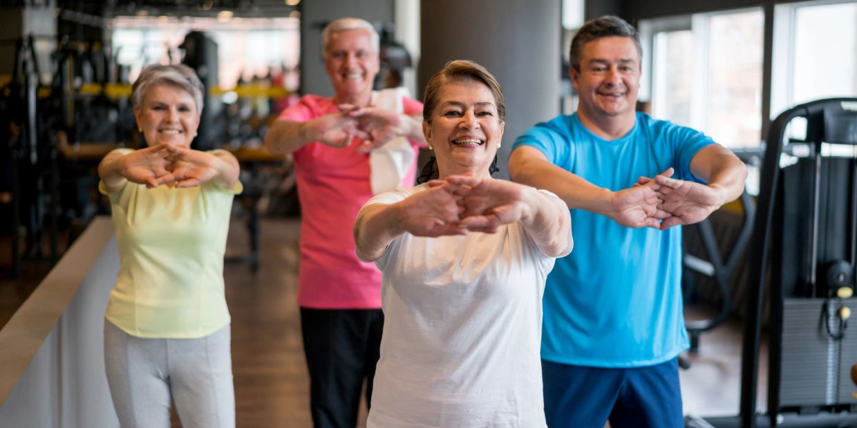 A group of seniors exercising together at a gym.