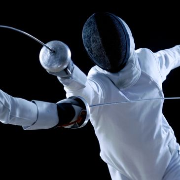 Two fencers in action, clashing swords mid-bout.