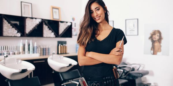 Smiling hairstylist in a salon.