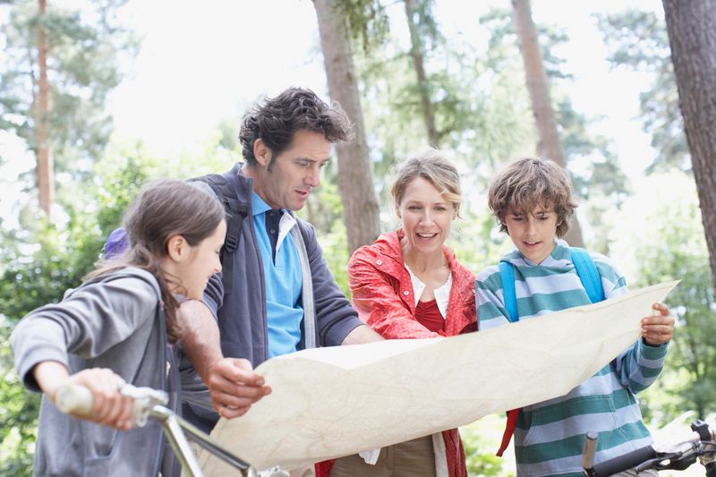 Family looking at map in woods