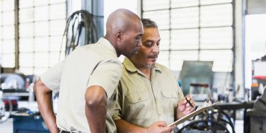 Two men discussing work in a workshop.