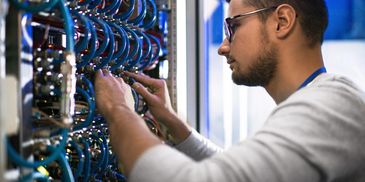 Man working on network rack