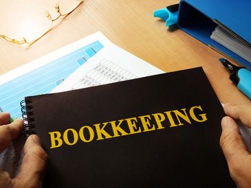 Bookkeeping notebook front cover on workspace