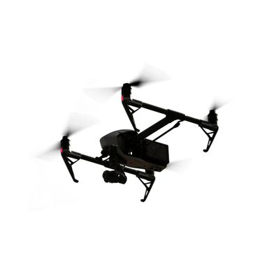 Black drone flying with spinning propellers against a white background.