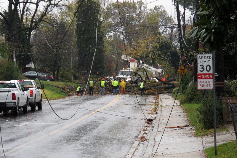 Construction workers repair damage to power lines after a tornado.
