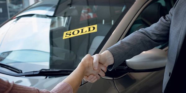 Hand shake after a car deal