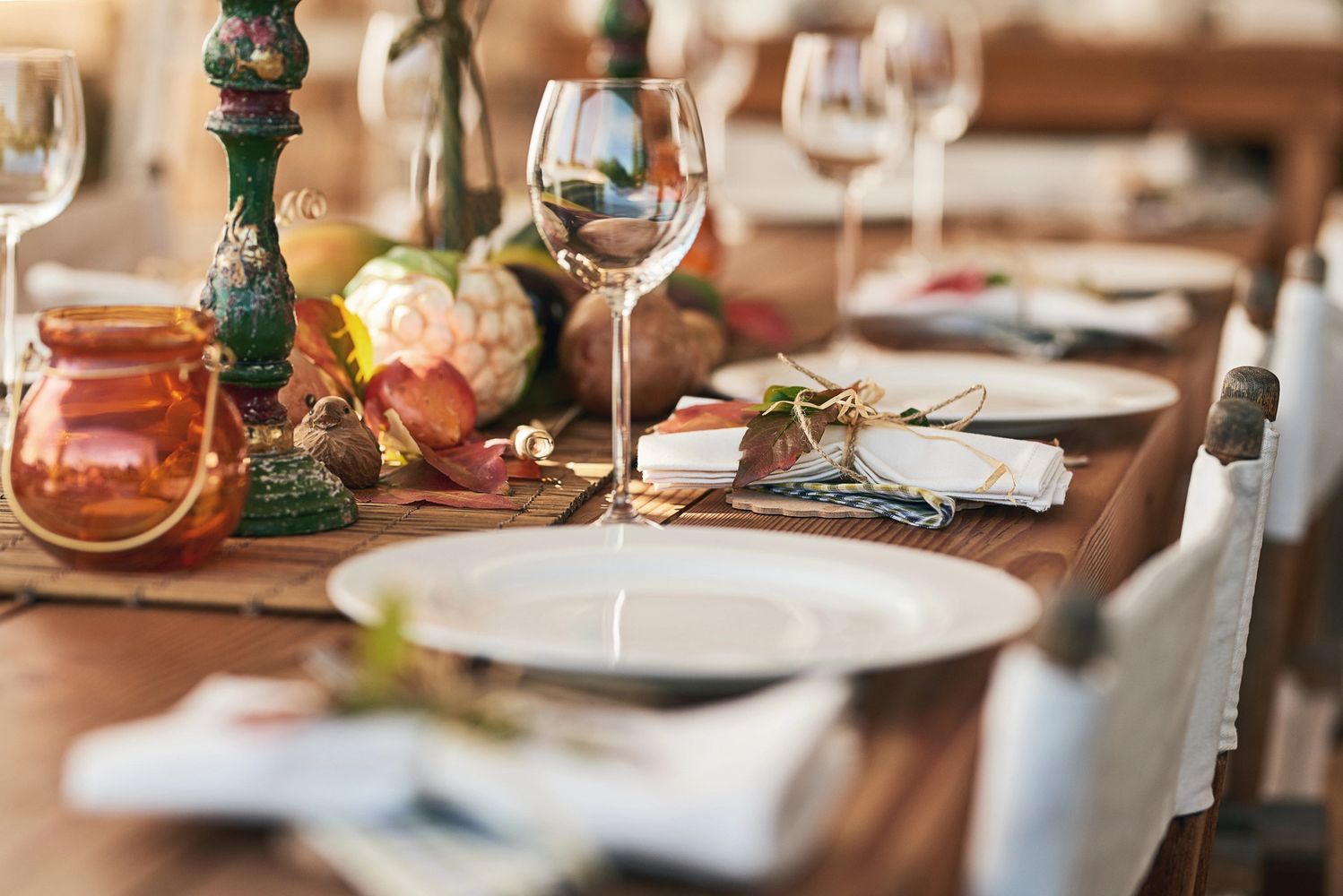 Autumn-themed dining table with elegant glassware and rustic decor.