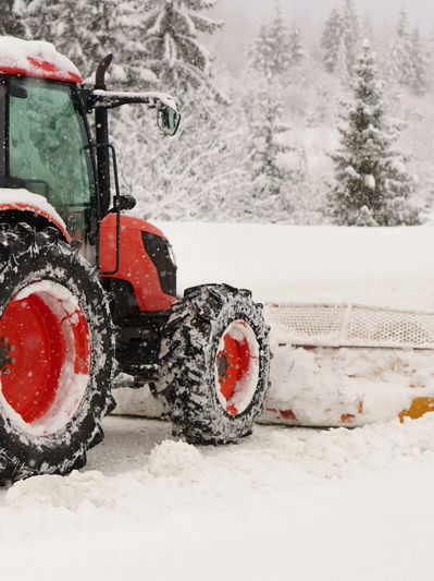Heavy Equipment doing snow removal for a resident's house or commercial building. 