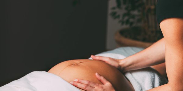 Therapist providing caring prenatal massage support at Wholly Spirit Hands in Sugar Land TX.