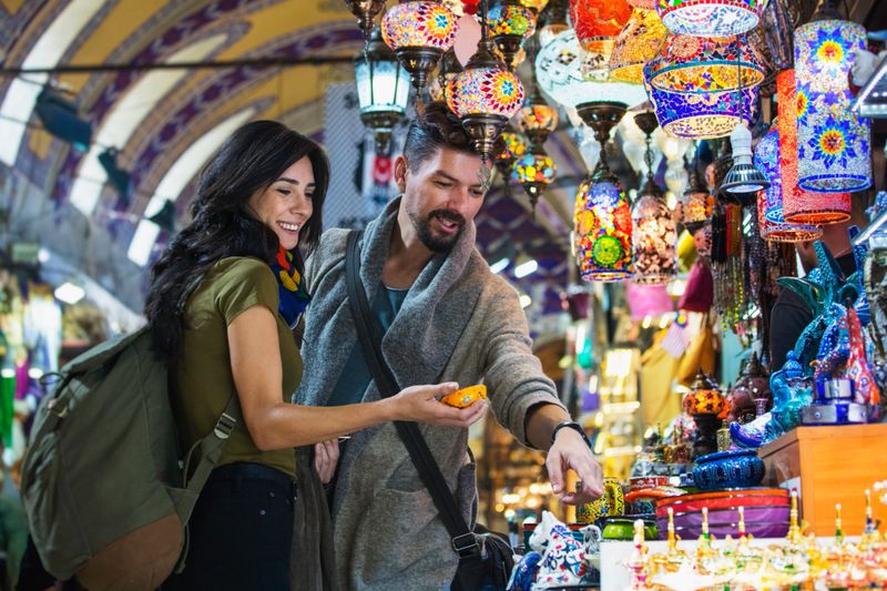 Young tourist couple shopping in in Grand Bazaar, Istanbul, Turkey