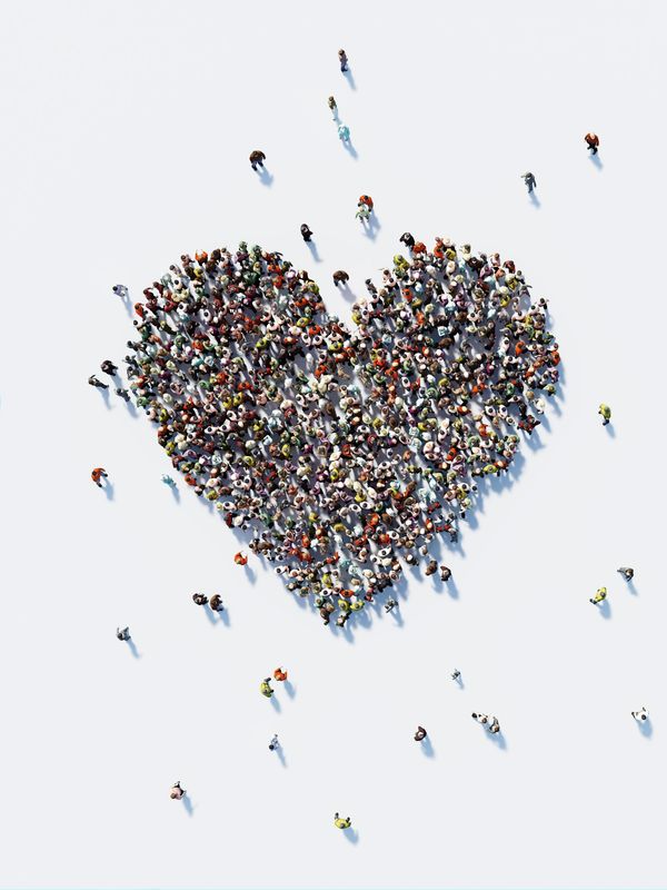 People forming a heart shape.