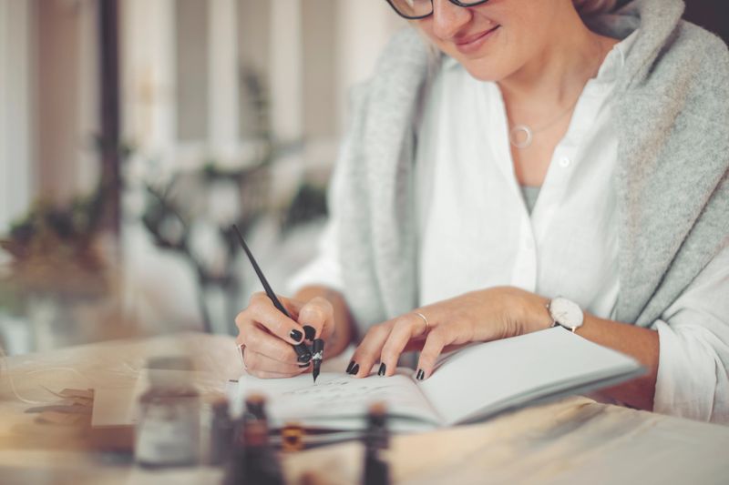 Young businesswoman is writing in a personal organizer