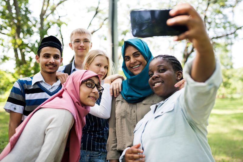 Group of students using mobile phone