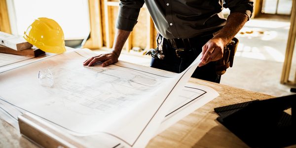 Local contractor reviewing construction plans for an ADU