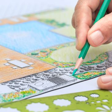 Hand coloring a detailed landscape architecture design with colored pencils.