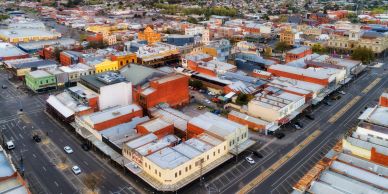 Aerial view of a busy urban area with various buildings and streets.