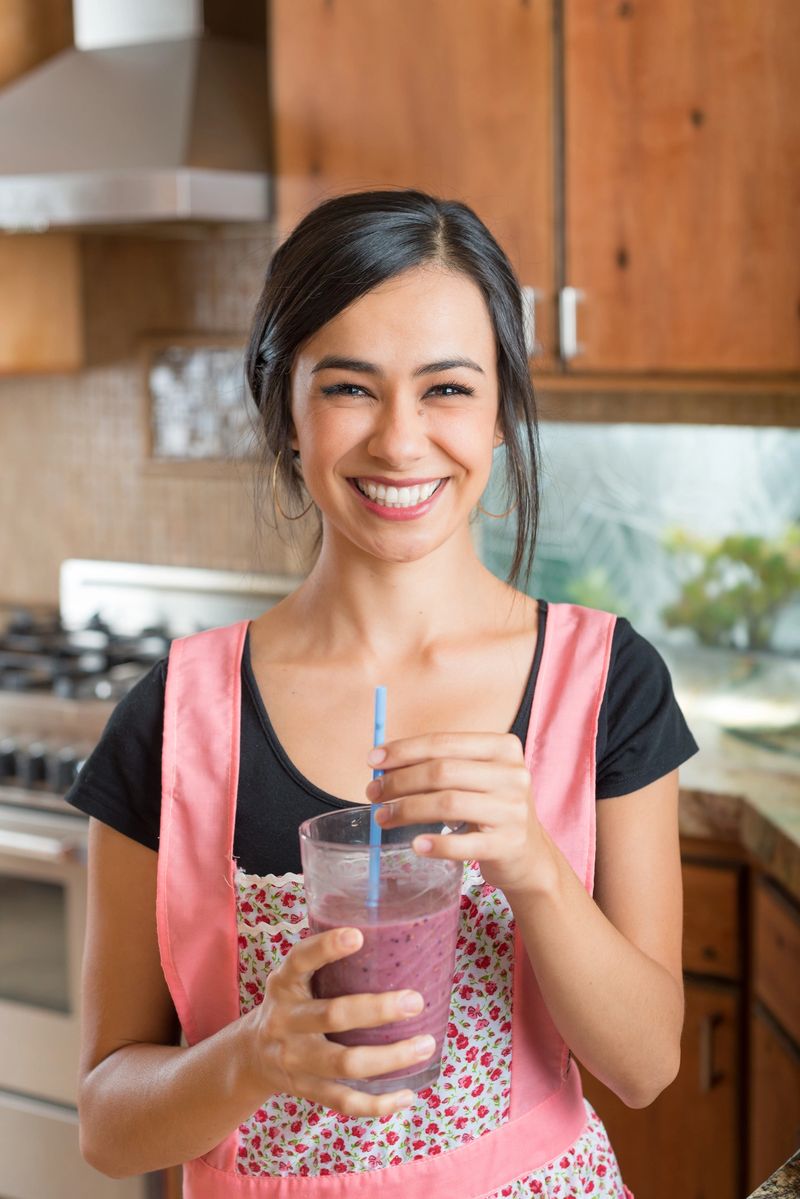 Hispanic Women In The Kitchen Making A Smoothie
