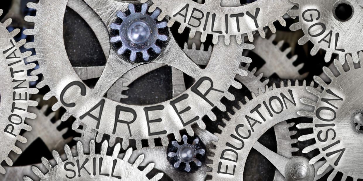 Metal gears with career-related words engraved on them.