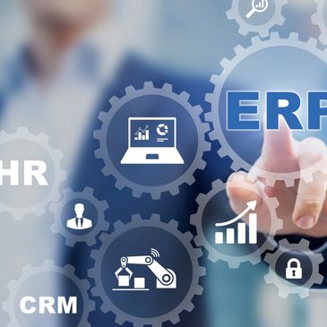 Person interacting with digital ERP system icons and data analytics.