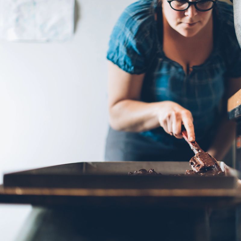 A young woman making brownies in a bakery. Small business in Canada. Baker
