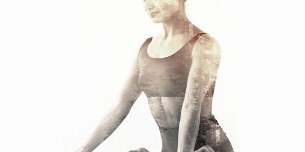 Artistic double exposure of a woman in workout attire performing yoga.