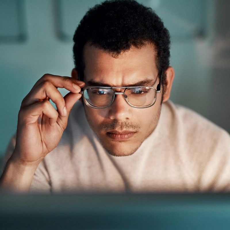 Shot of a young businessman working late at the office