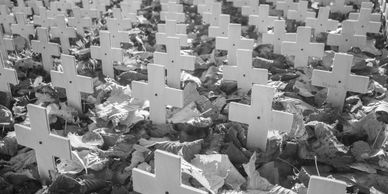 Wooden crosses on a ground covered with autumn leaves.