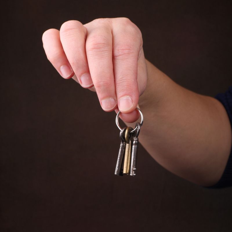 ordinary womans hands dangling a bunch of keys