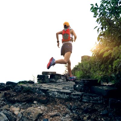 Person jogging outdoors on rocky terrain