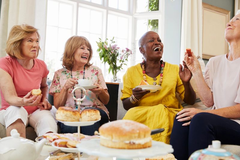 Senior Female Friends Enjoying Afternoon Tea At Home Together