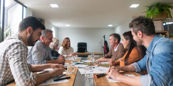 People having a collaborative meeting around a table.