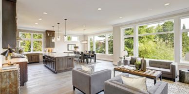 Bright open living room with large windows and modern furniture.