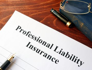 Professional liability insurance document on desk.