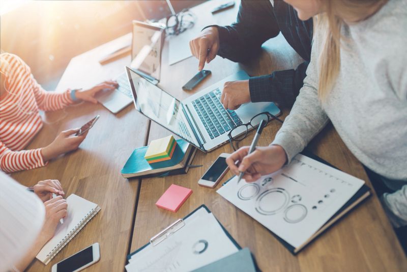 Meeting room situation. General business discussion in cozy open space office. Four people