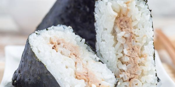 Triangular onigiri rice balls wrapped in seaweed with a tuna filling.