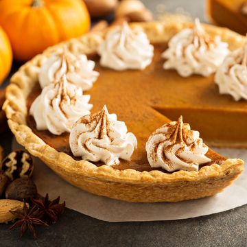 Pumpkin pie topped with whipped cream and cinnamon.