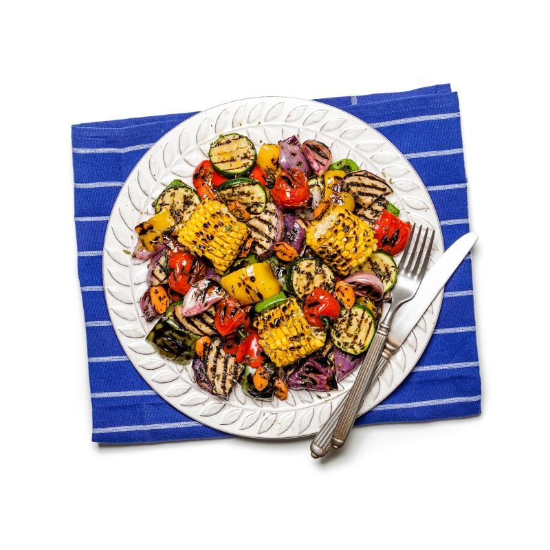 Grilled vegetables plate shot from above on white background. A blue textile napkin is under the plate. DSRL studio photo taken with Canon EOS 5D Mk II and Canon EF 100mm f/2.8L Macro IS USM