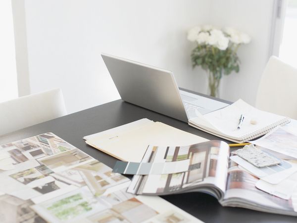 Workspace with laptop and architectural magazines.
