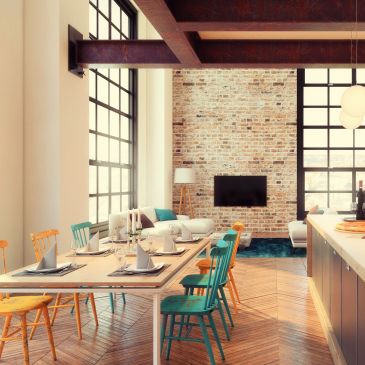 Modern dining area with colorful chairs and large windows.