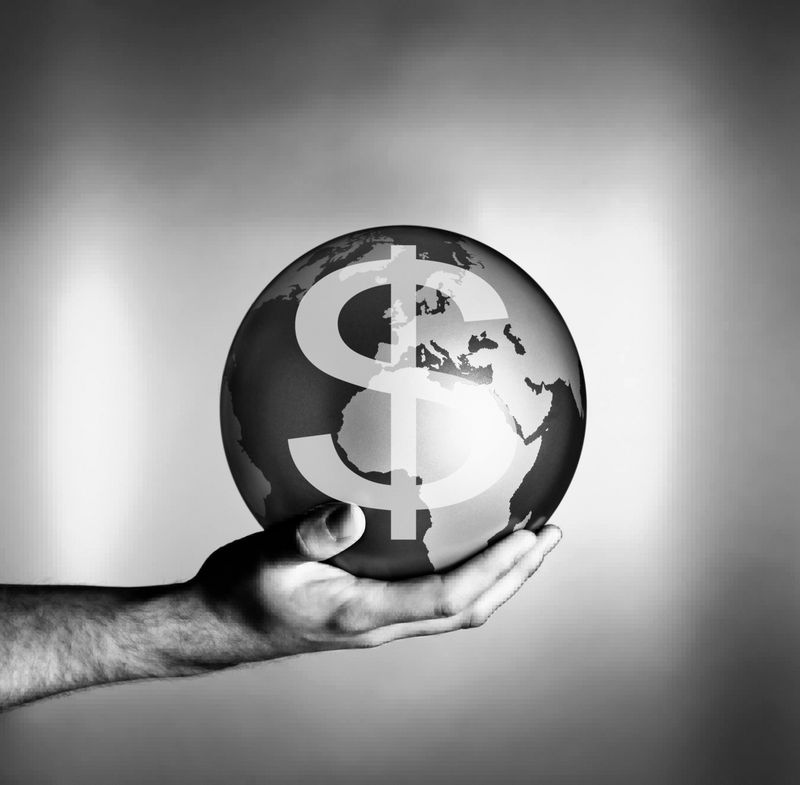 Man holding globe with dollar symbol
