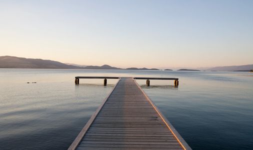 Sunset over tranquil waters, symbolizing peace and hope.
